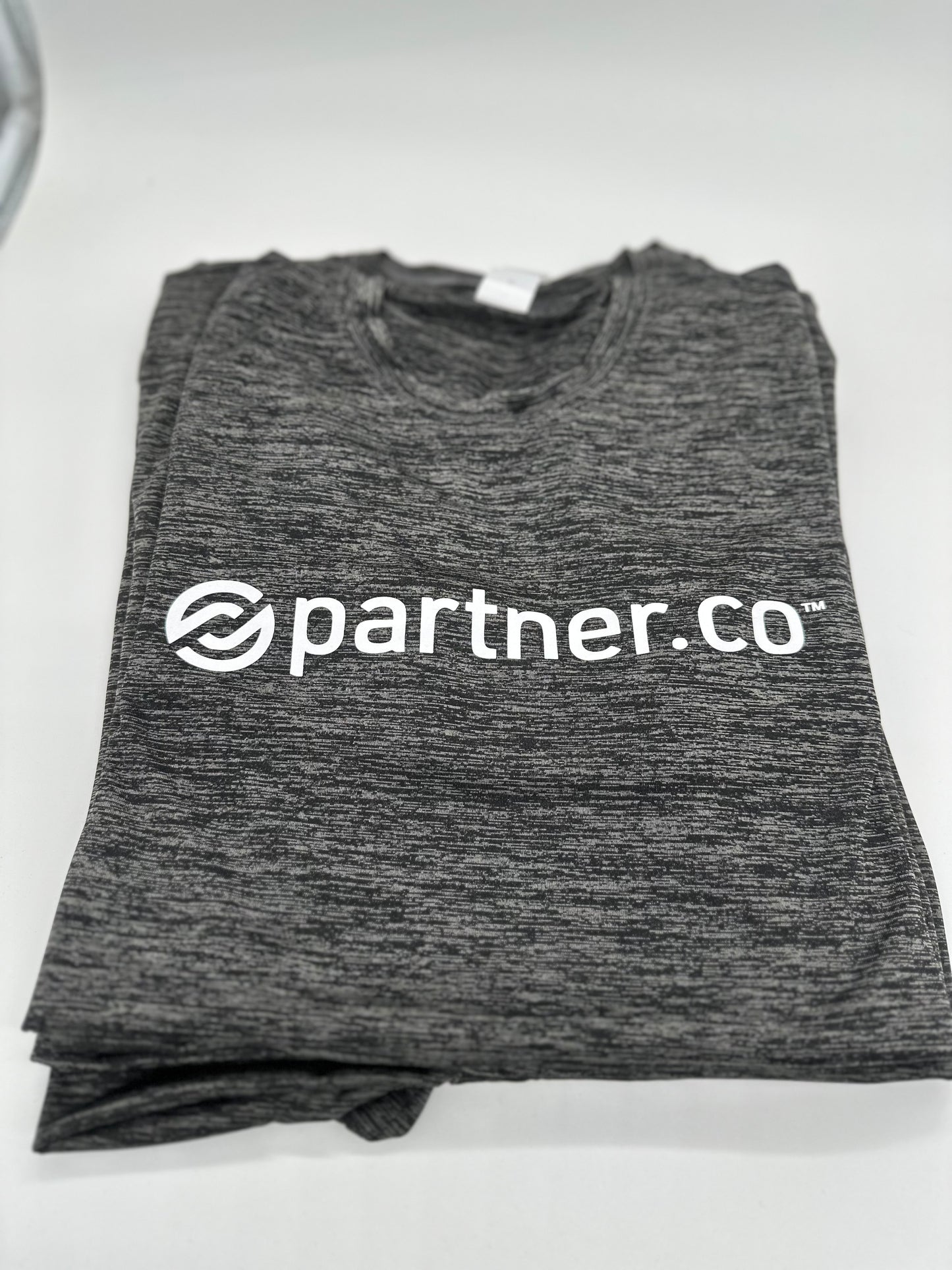 A gray t-shirt with the text 'partner.co' printed on the front.