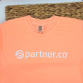 A neon cantaloupe short sleeve t-shirt with the 'partner.co' logo printed in white on the front.