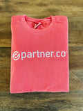 A folded red sweatshirt with the text 'partner.co' embroidered on the front.